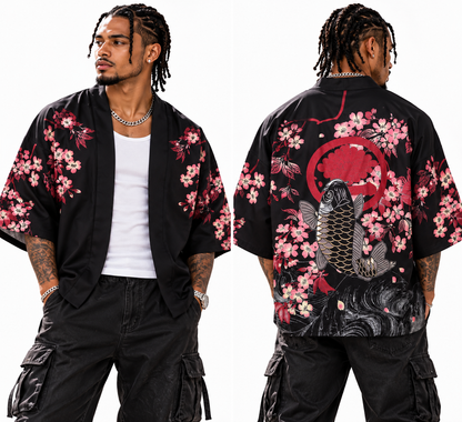 A man modeling a black short-sleeve open-front shirt jacket with pink and red cherry blossom floral print, shown from both front and back views against a plain white background.