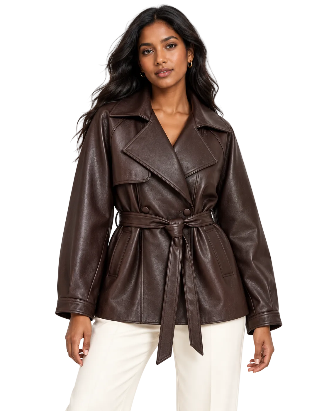 A woman modeling a dark brown faux-leather belted jacket with a double-breasted front and wide lapels, paired with cream pants, against a plain white studio background.