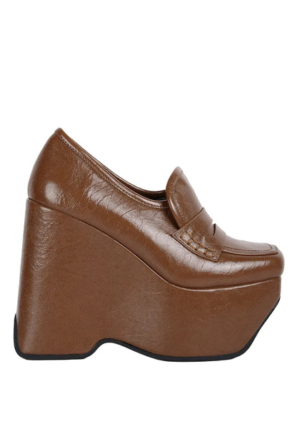 A single brown platform loafer shoe with a textured faux-leather finish, shown in a side profile view against a plain white background.