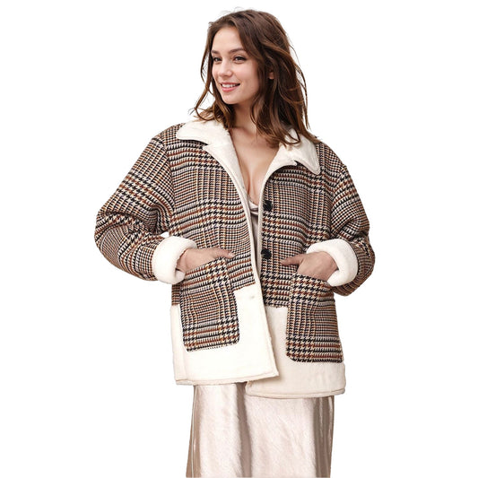 Woman wearing a plaid jacket with white trim on a white background