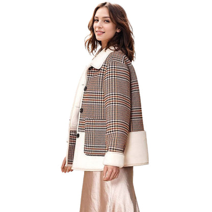 Woman wearing a checkered coat with white trim on a white background
