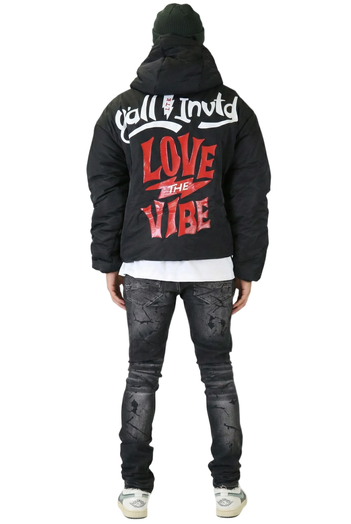 Person wearing a black hoodie with text on the back, standing against a white background