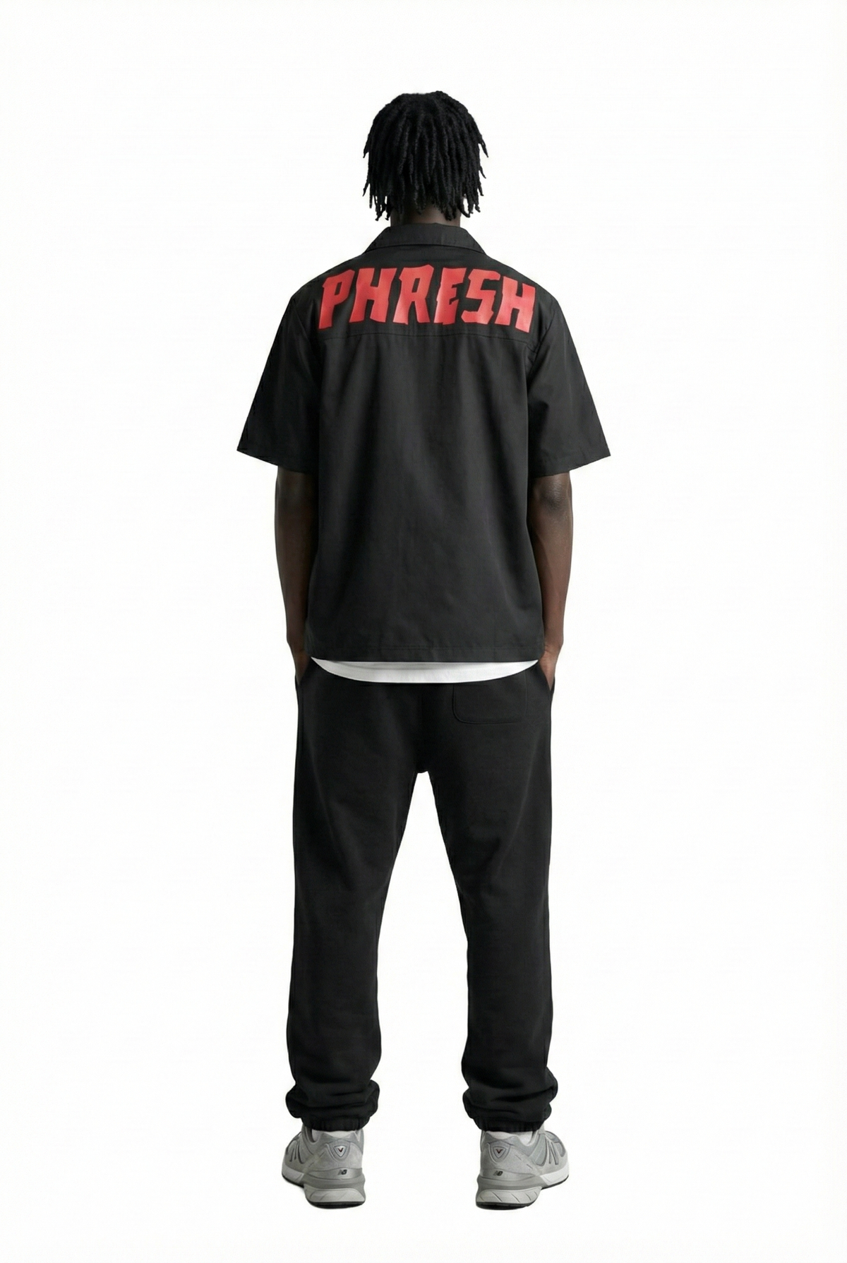 Person wearing a black shirt with 'PHRESH' text on the back, standing against a white background