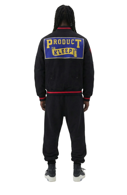 Person wearing a black tracksuit with 'Product Kleep' logo on the back against a white background