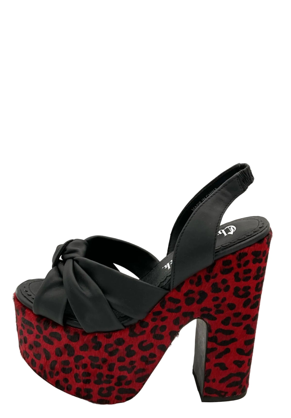 A single platform slingback sandal with a black satin bow and straps, featuring a red and black leopard print platform sole and block heel, photographed on a white background.