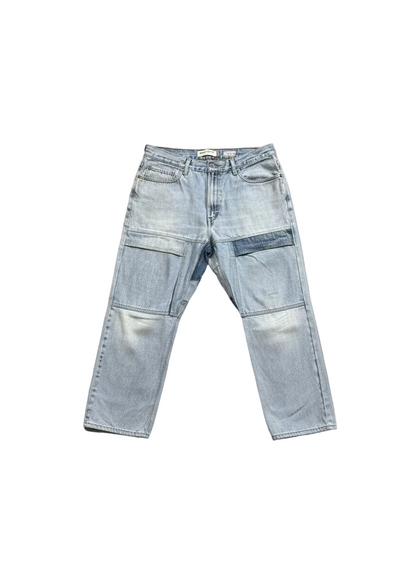 Light wash blue denim cargo pants with multiple utility pockets, shown flat against a white background.