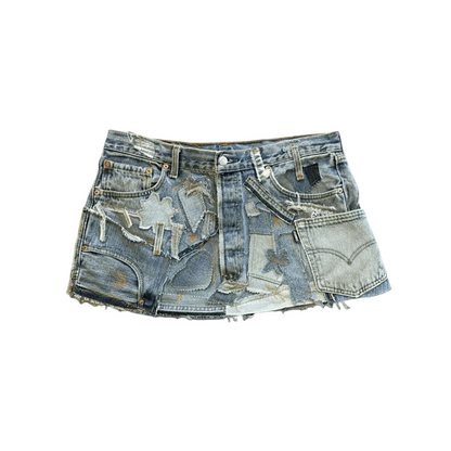 A pair of heavily distressed and ripped light-wash blue denim shorts with frayed edges, displayed flat against a solid gray background.