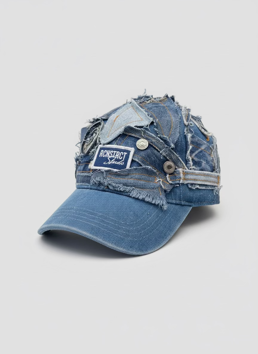 A distressed denim baseball cap with layered patchwork denim panels, frayed edges, and a visible 'Moncler Supreme' patch on the front, photographed on a light gray background.