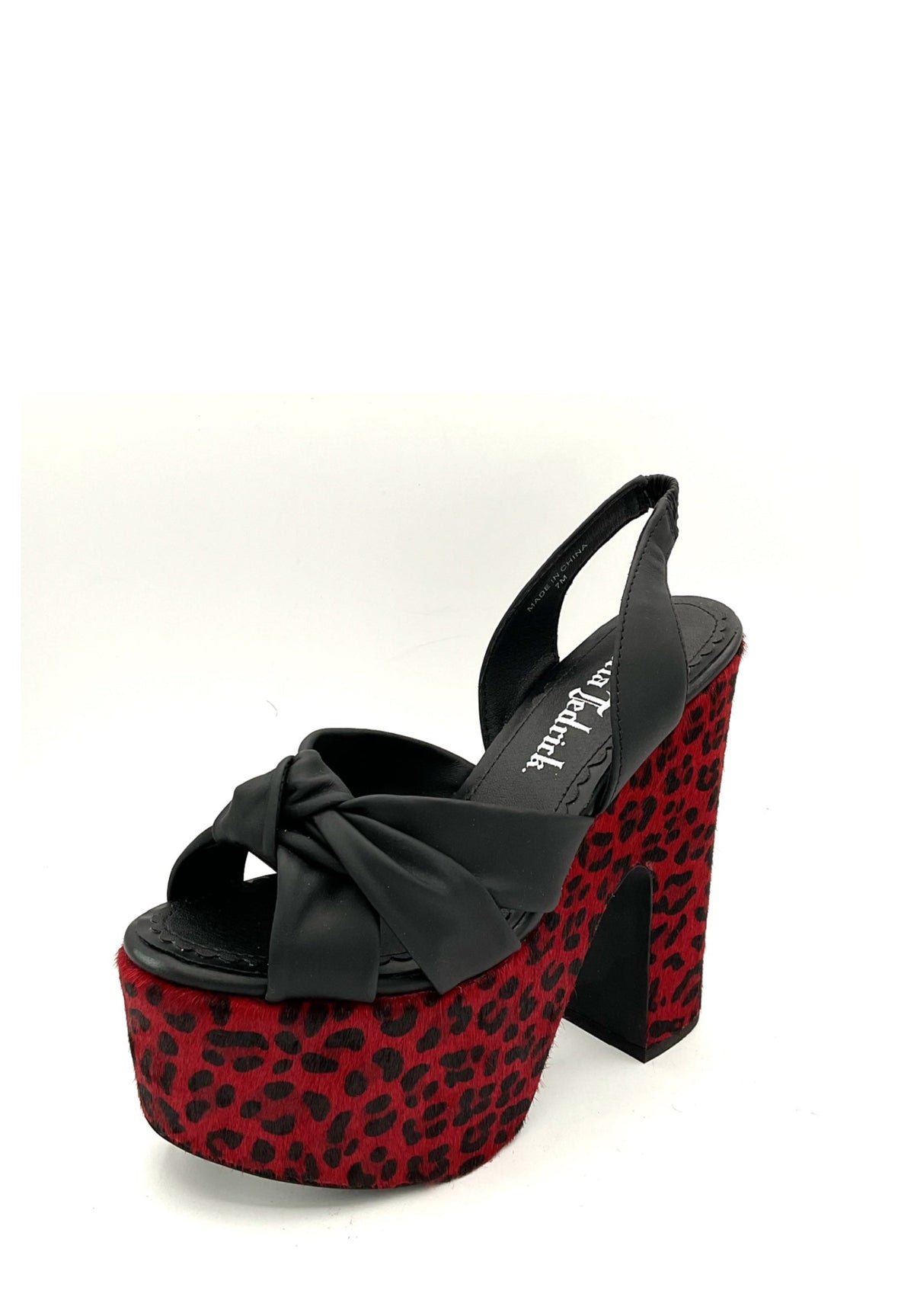 Black platform sandal with red leopard print sole on a white background