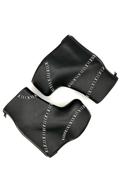 Black leather glove with white stitching on a white background