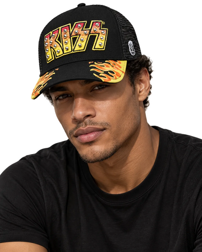 A man wearing a black KISS trucker hat with a yellow, red, and blue logo on the front and flame patterns on the brim, paired with a black t-shirt.