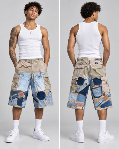 A model shown from the front and back wearing a pair of beige cargo shorts with a patchwork design combining denim and camouflage patterns, styled with a white tank top, white socks, and white sneakers against a light gray studio background.