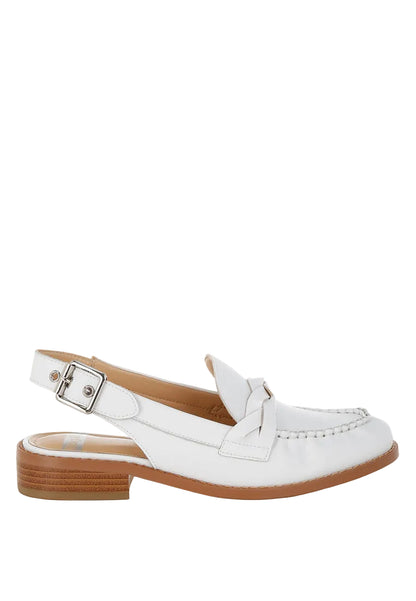 White loafer shoe with a brown sole on a light blue background