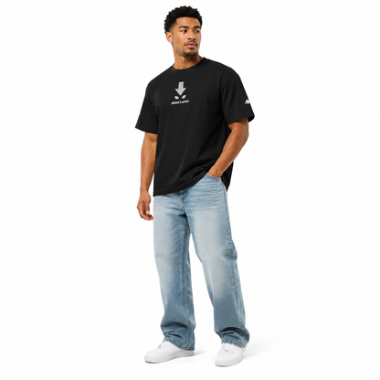 Man wearing a black t-shirt and light blue jeans on a white background