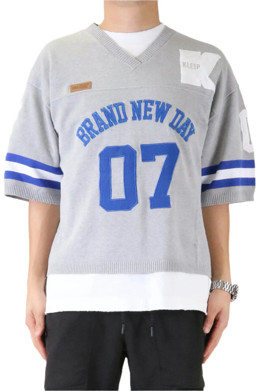 Gray sports jersey with 'Brand New Day 07' text and blue accents worn by a person.
