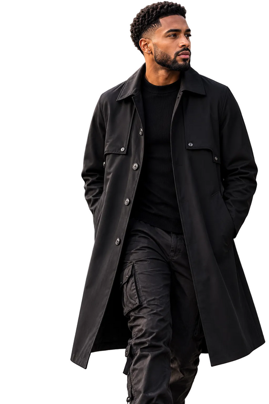 A man wearing a long black trench coat over a black outfit walks outdoors, with the KRIFFA brand logo and text overlay on the left side of the image.
