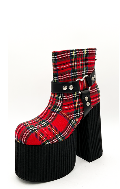 Red plaid platform boot with black sole on a white background