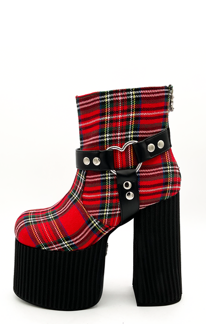 Plaid platform boot with a buckle on a white background