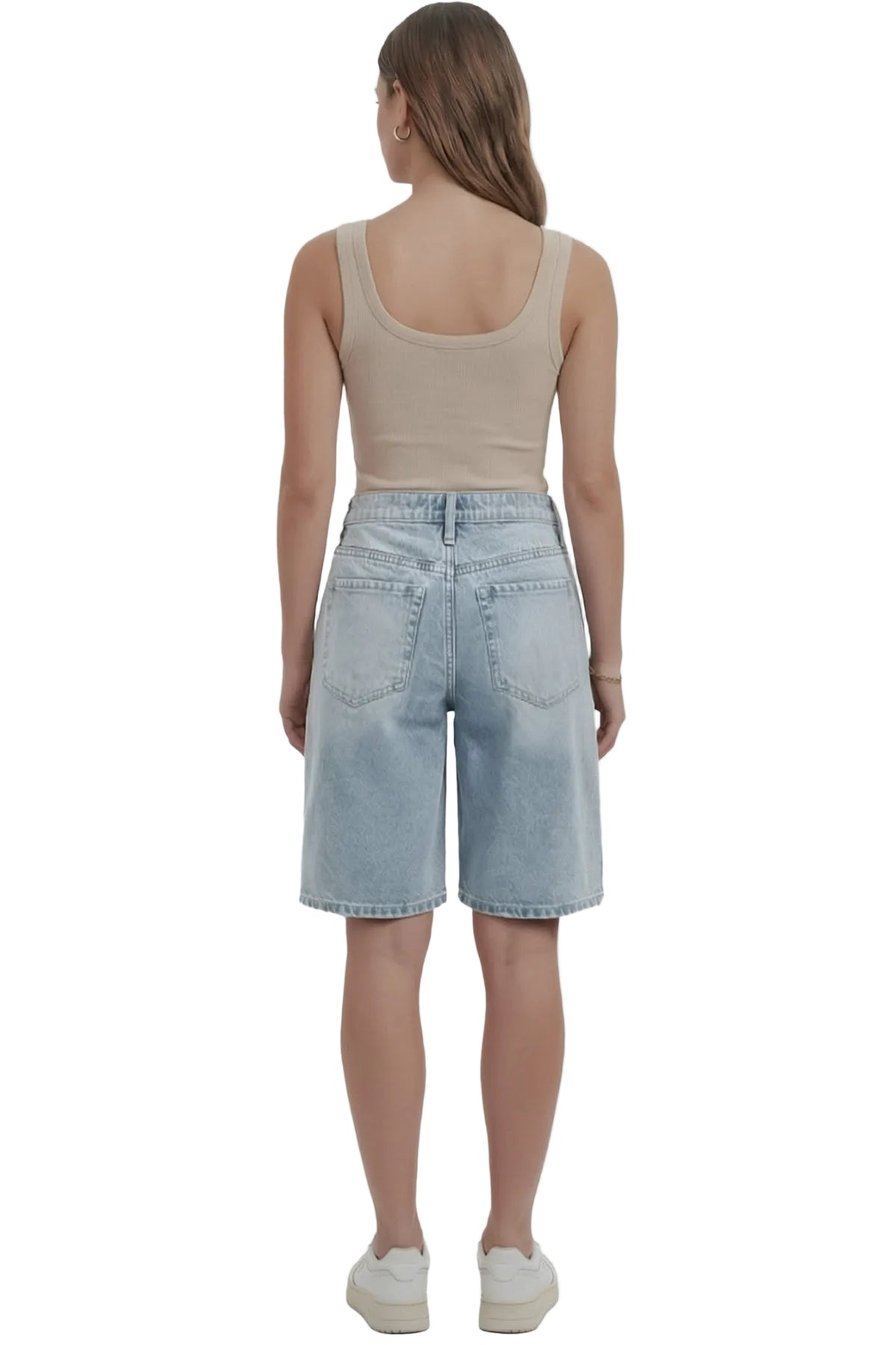 Person wearing a beige tank top and light blue denim shorts on a white background