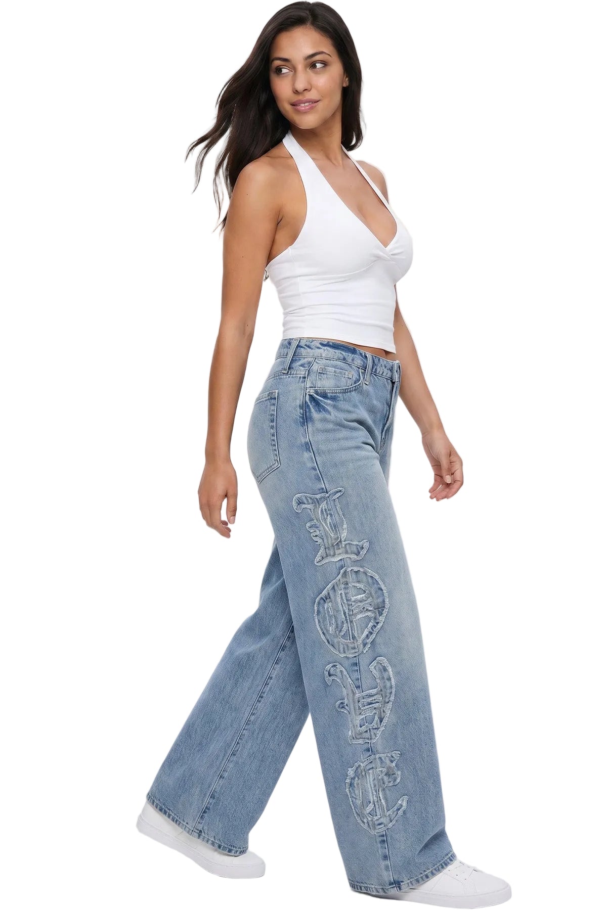 Woman wearing light blue jeans and a white top on a white background