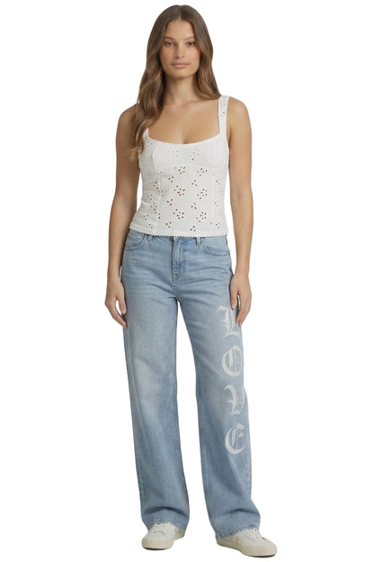 Woman wearing a white lace top and light blue jeans with 'Peace' text on a white background