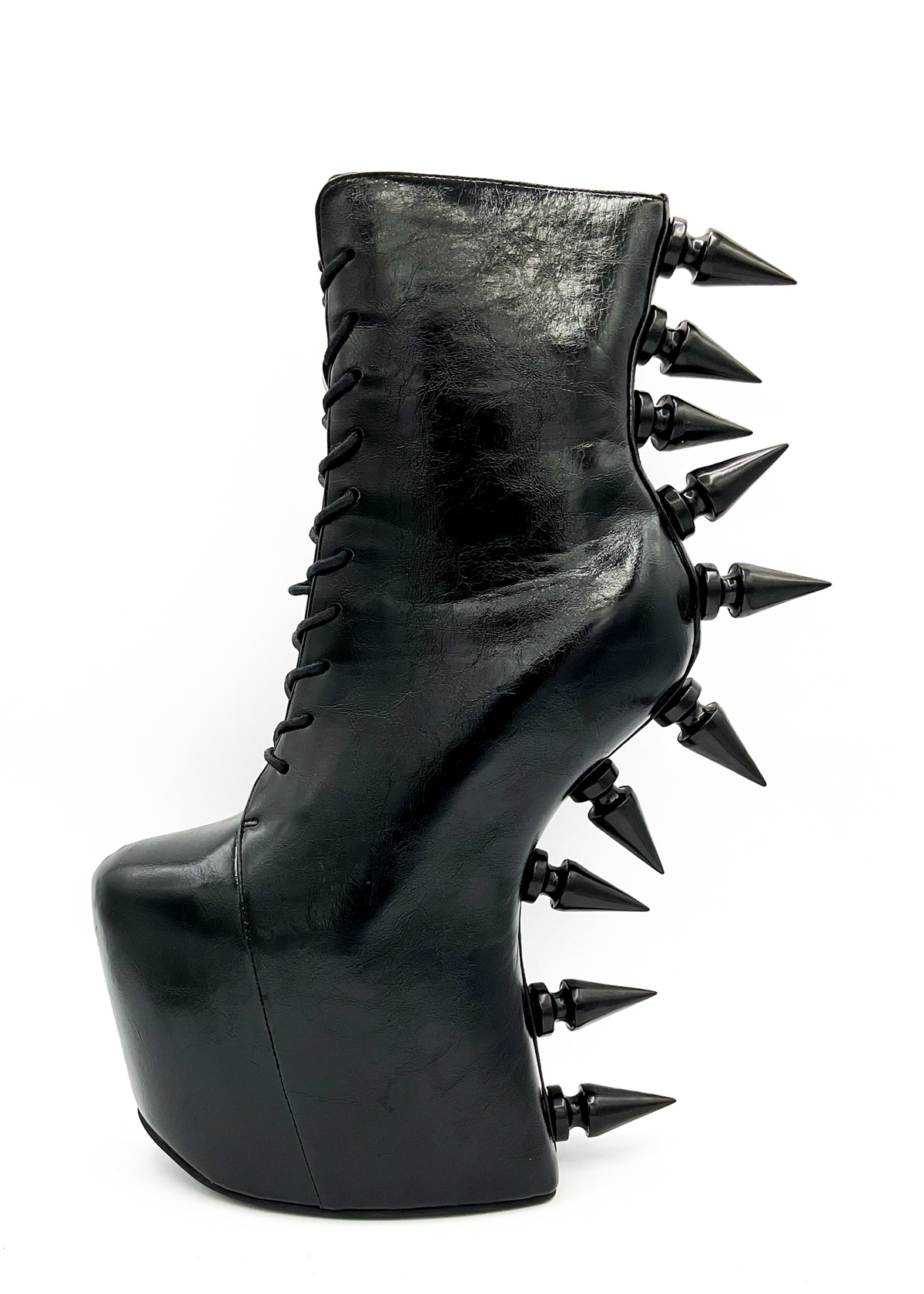Black platform boot with spikes on a white background
