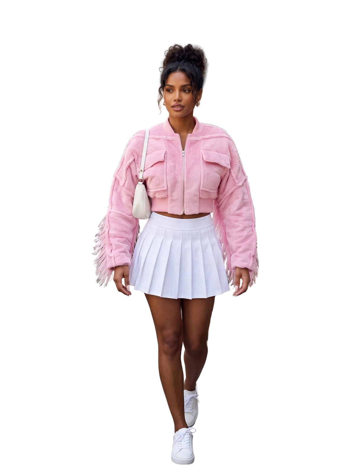 A woman walking down a city sidewalk at an outdoor cafe, wearing a pink cropped bomber jacket with fringe details, a white pleated tennis skirt, and white sneakers.