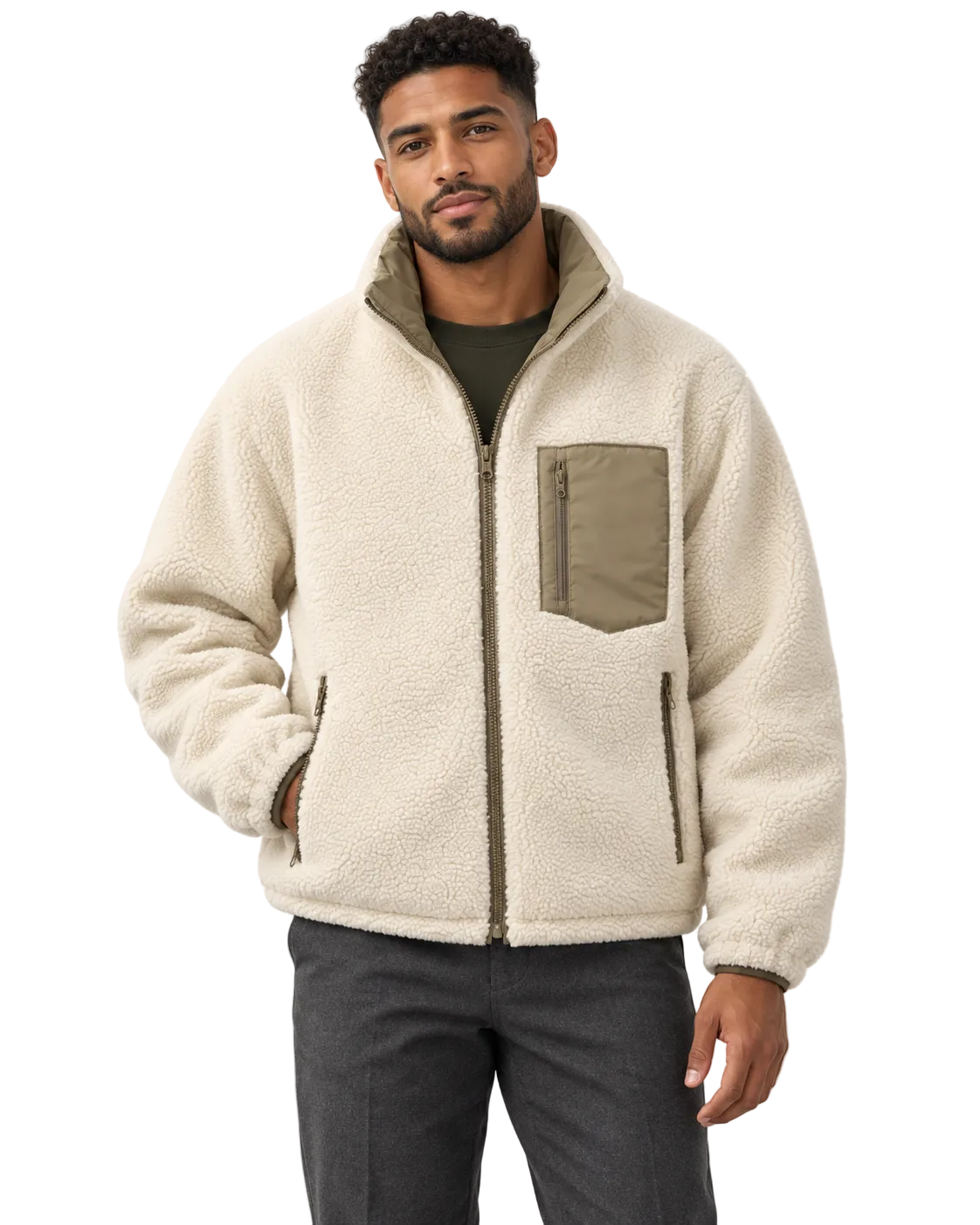 A man wearing a cream sherpa fleece zip-up jacket with olive green accents on the chest pocket and zipper details, paired with dark gray pants, against a plain white background.