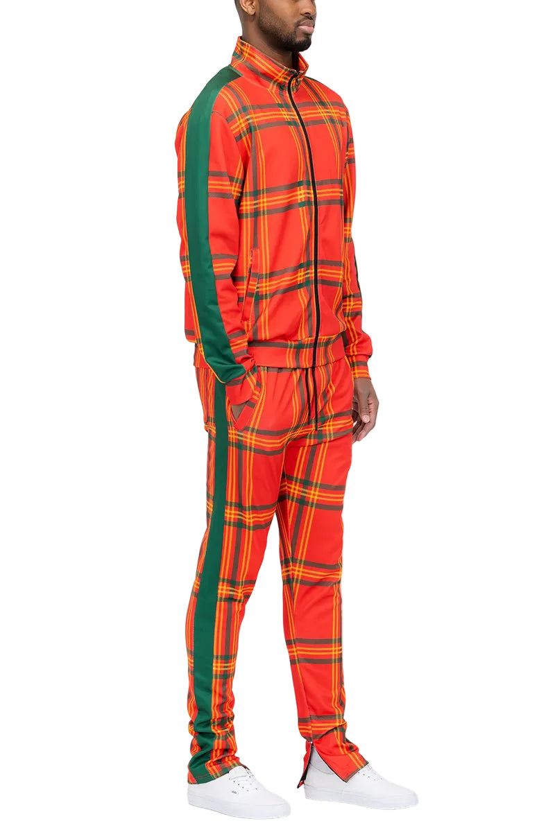 Person wearing a bright orange plaid tracksuit with green accents on a white background