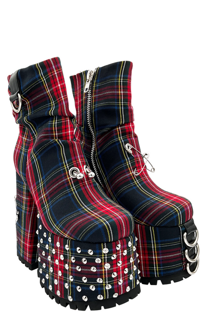 Plaid platform boots with studded details on a white background