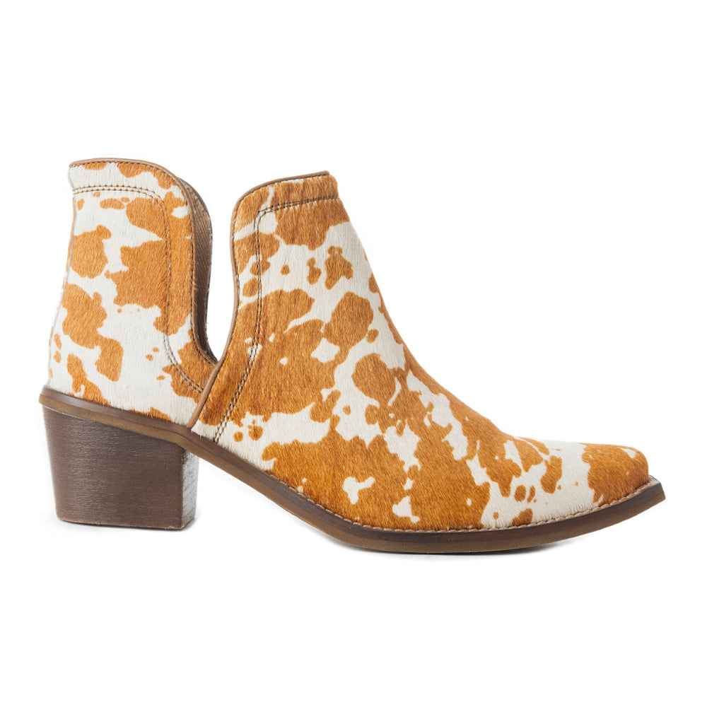 Cow print ankle boot on a white background
