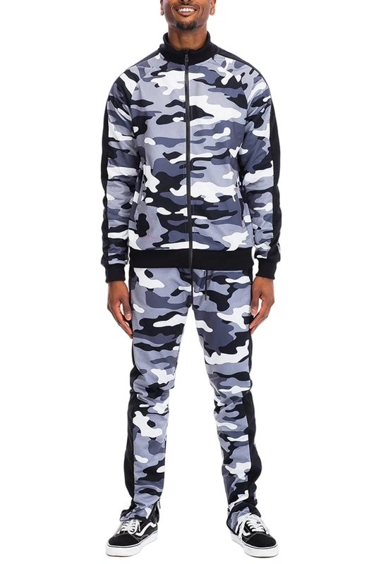 Person wearing a gray and black camouflage tracksuit on a white background