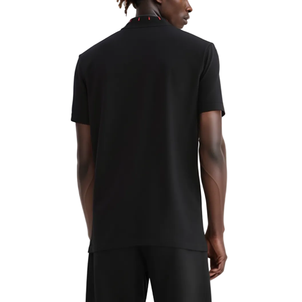 Person wearing a black polo shirt on a white background