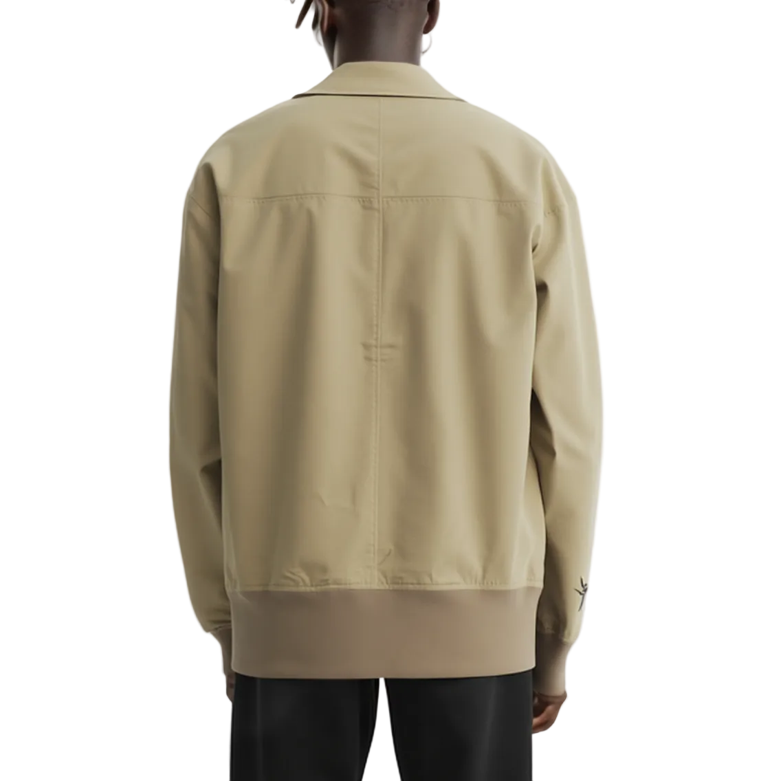 Beige jacket worn by a person on a white background