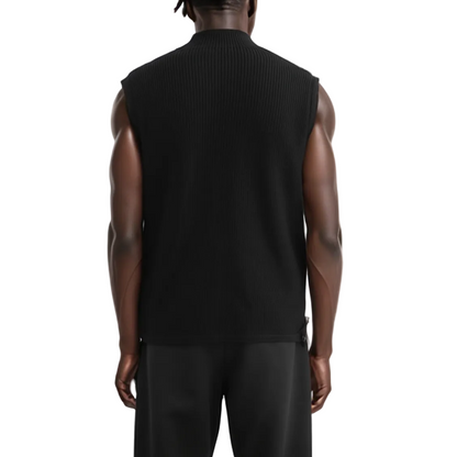 Person wearing a black sleeveless sweater on a white background