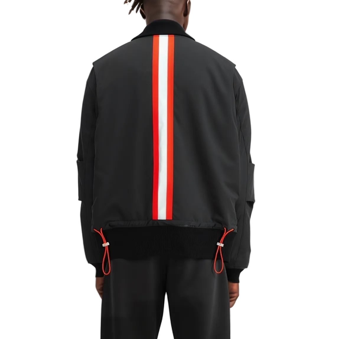 A person shown from the back wearing a black bomber-style jacket with a bold vertical red and white stripe down the center back, paired with black pants against a plain light background.