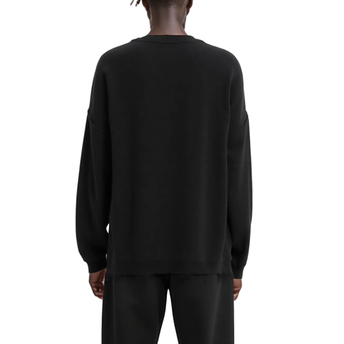 Person wearing a black sweatshirt and pants on a white background