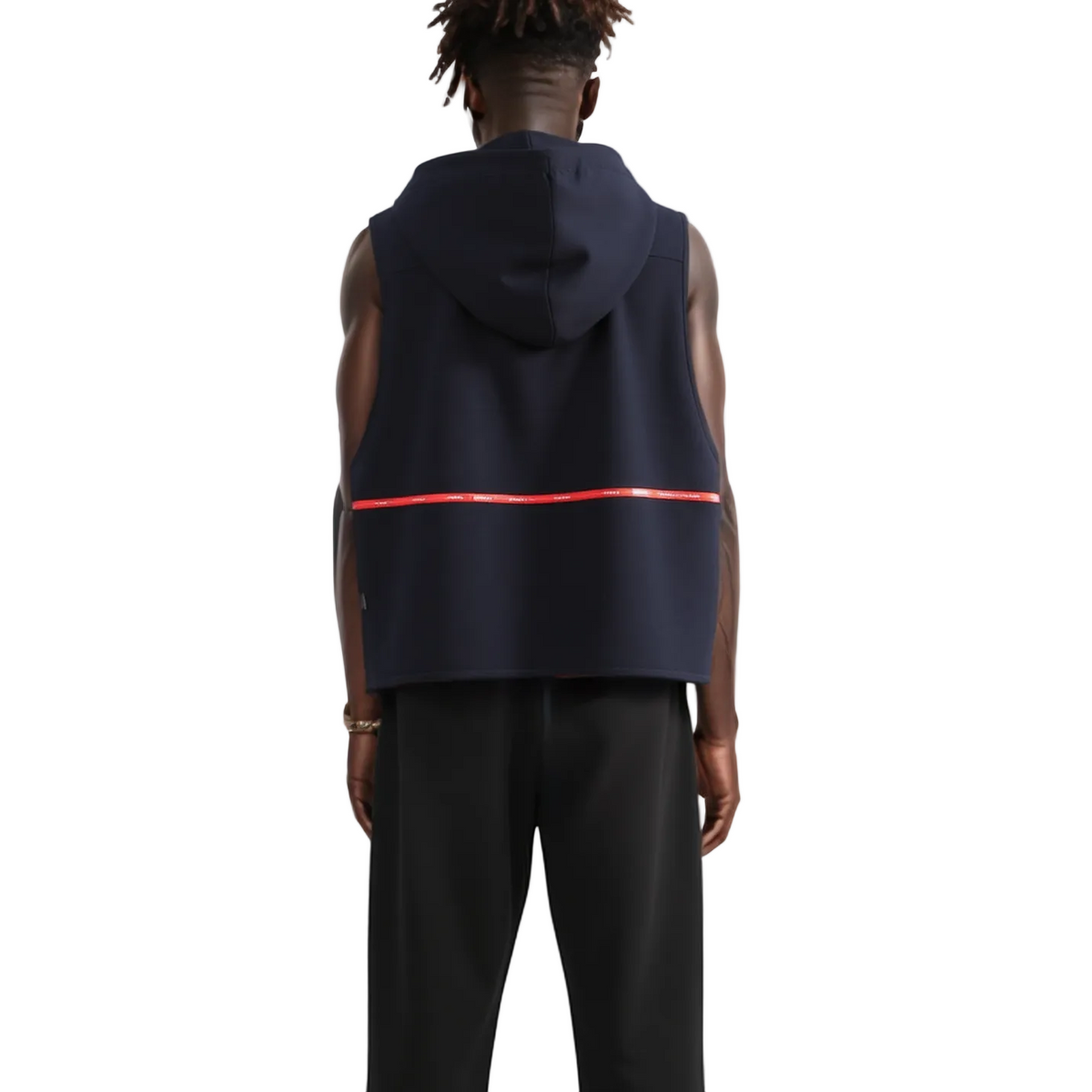Person wearing a navy sleeveless hoodie with a red stripe on a white background