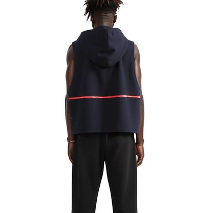 Person wearing a navy sleeveless hoodie with a red stripe on a white background