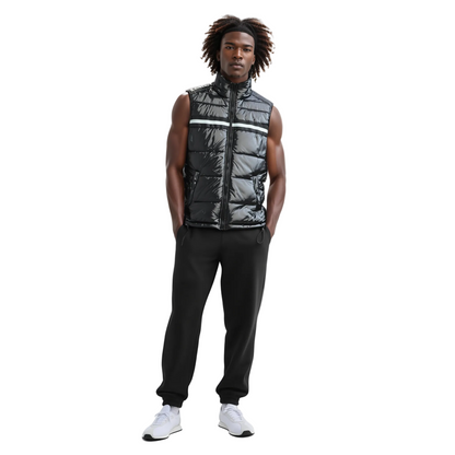 Man wearing a black puffer vest with reflective stripes on a white background