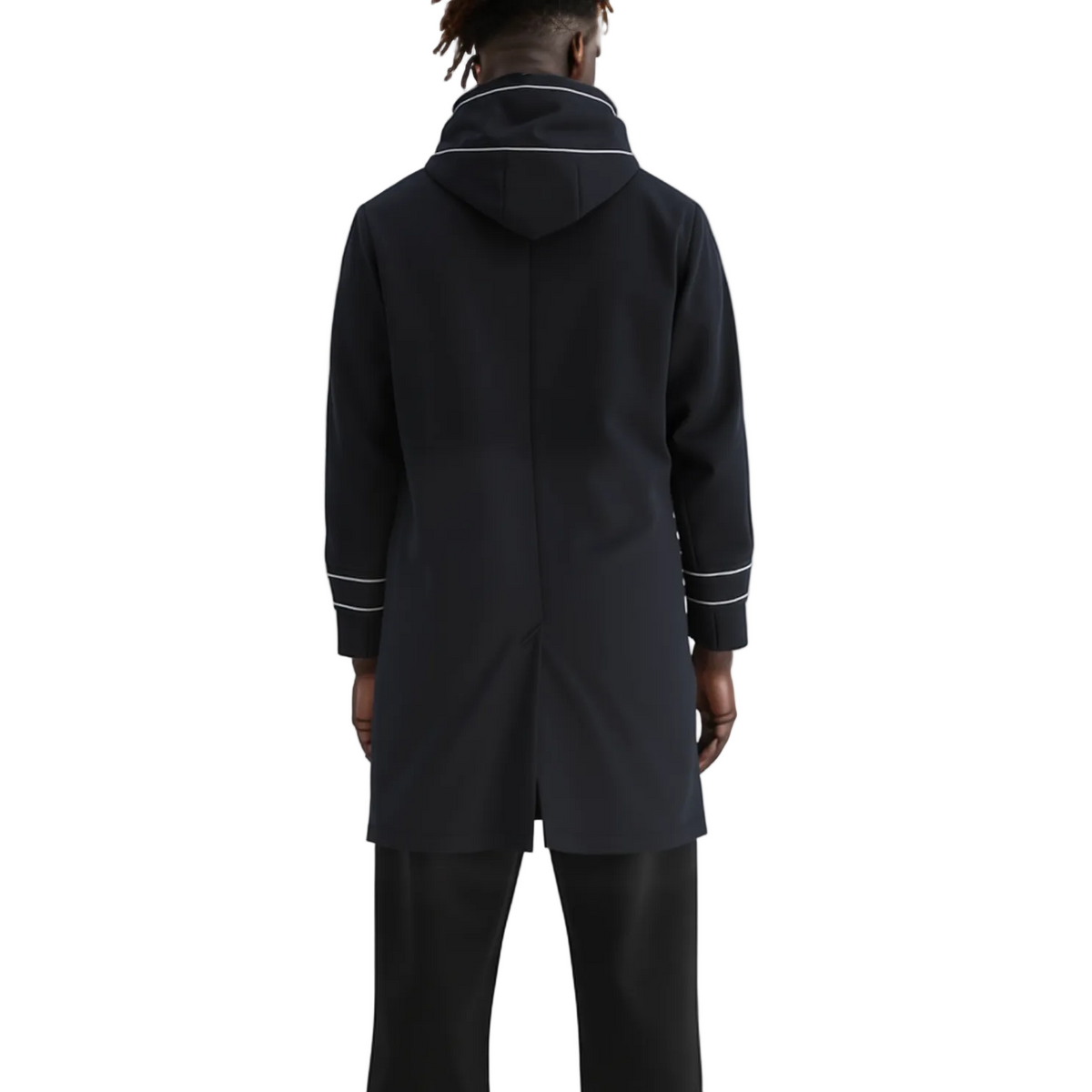 A model shown from the back wearing a black hooded coat with white contrast piping details on the collar and cuffs, paired with black trousers, against a plain white studio background.