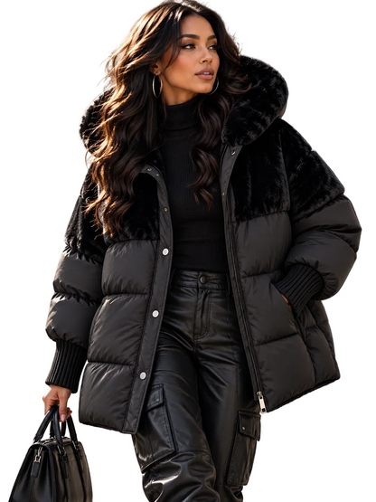 A woman wearing a black puffer jacket with a plush faux-fur collar, styled with black cargo pants and holding a black handbag on a city sidewalk.
