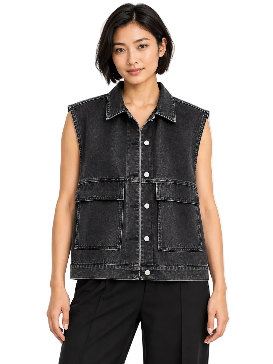 A woman wearing a sleeveless black denim vest with a button-down front and two large front flap pockets, paired with black pants, against a plain white background.