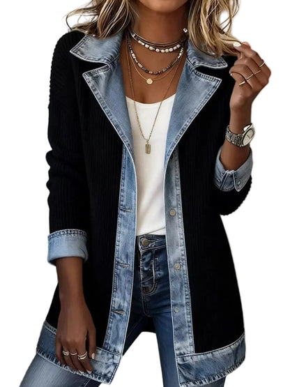 A woman wearing a black ribbed knit cardigan with light blue denim trim and collar, layered over a white top and blue jeans.