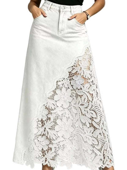 White denim midi skirt with a large floral lace overlay panel on the front, shown on a model with hands in pockets against a light gray background.