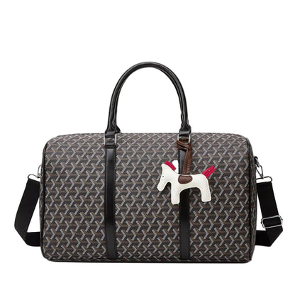 A Goyardine monogram duffel bag in dark gray and brown with black leather handles and trim, featuring a white horse charm with red accents.