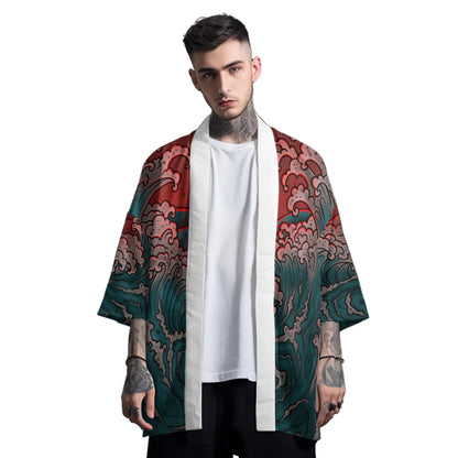 Man wearing a colorful kimono-style garment over a white shirt on a gray background