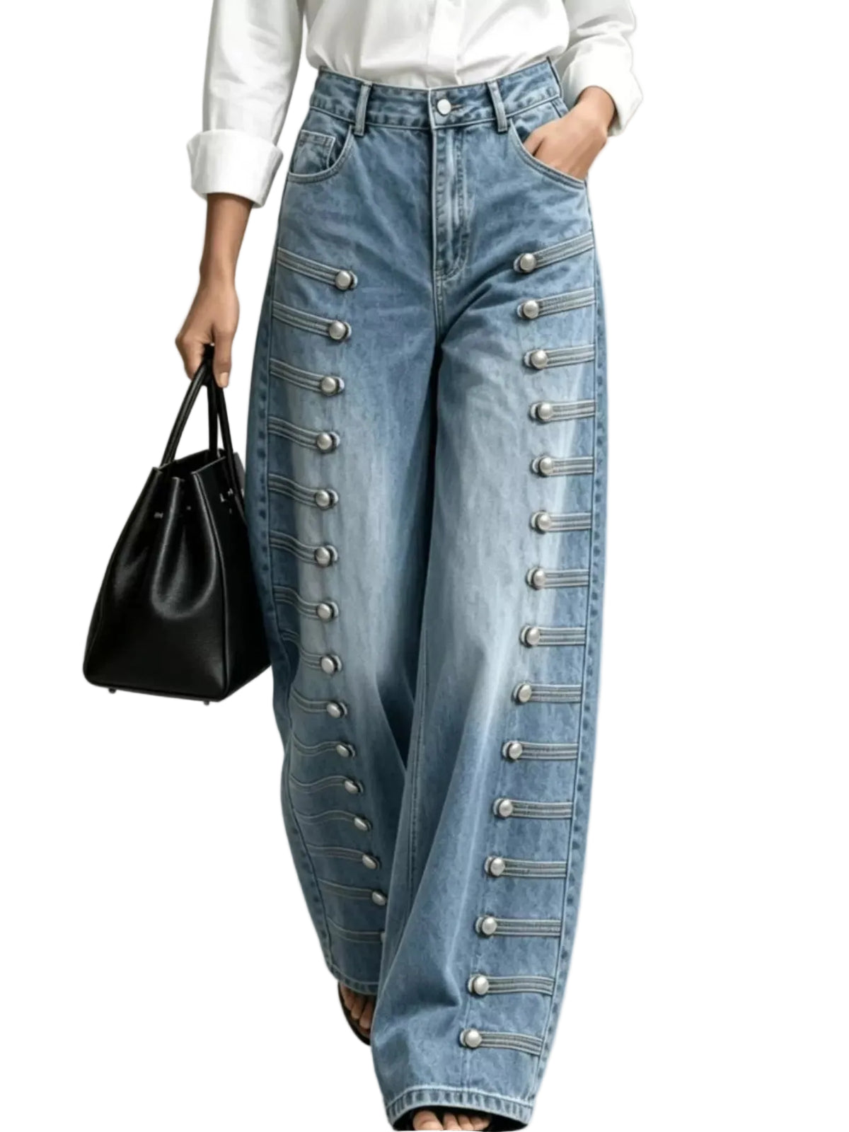 A person wearing light blue wide-leg denim jeans with decorative silver-tone military-style button and cord details down the front, paired with a white top and holding a black handbag against a light gray studio background.