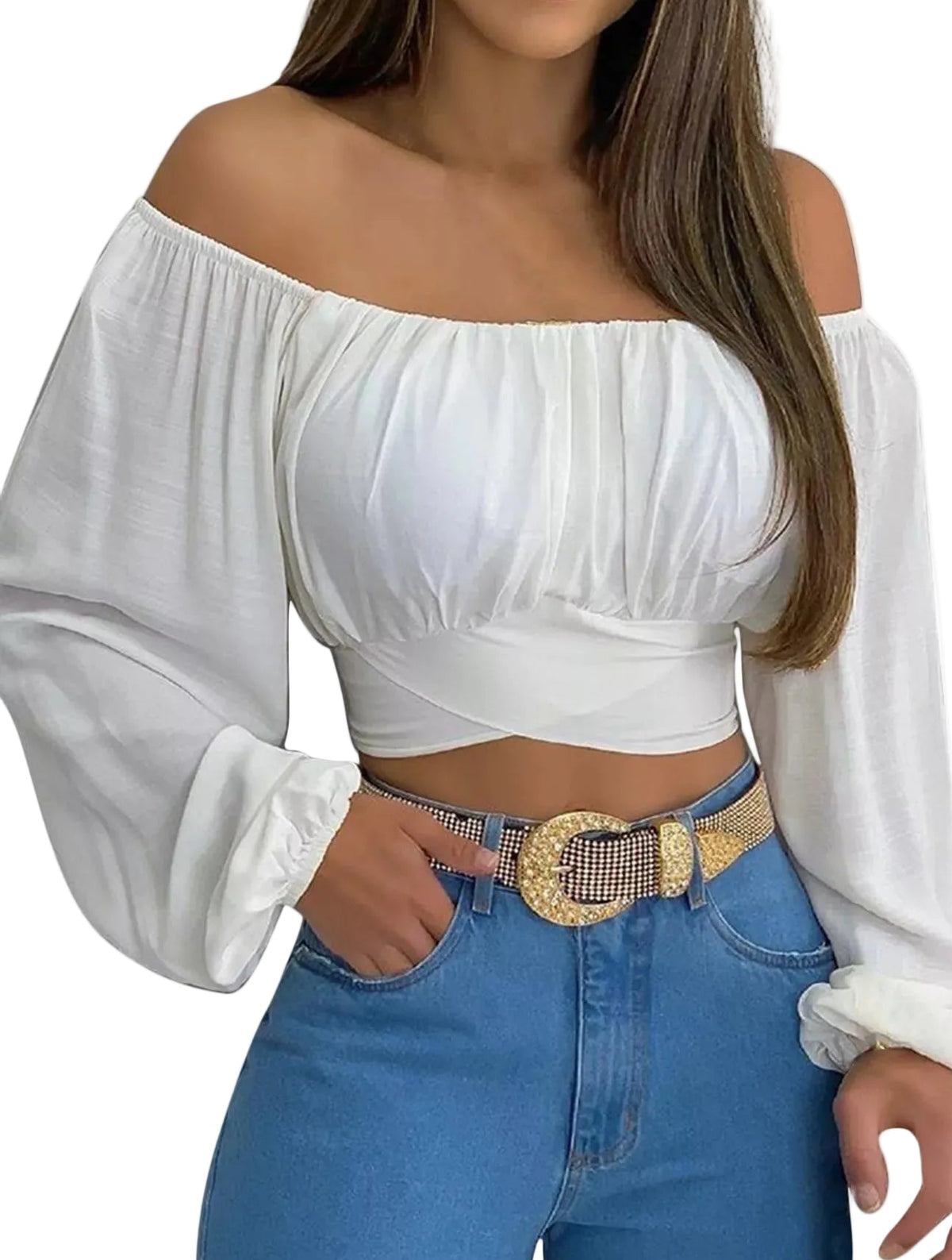 A woman wearing a white off-the-shoulder long-sleeve crop top with gathered puff sleeves, paired with blue jeans and a patterned belt, against a plain white background.