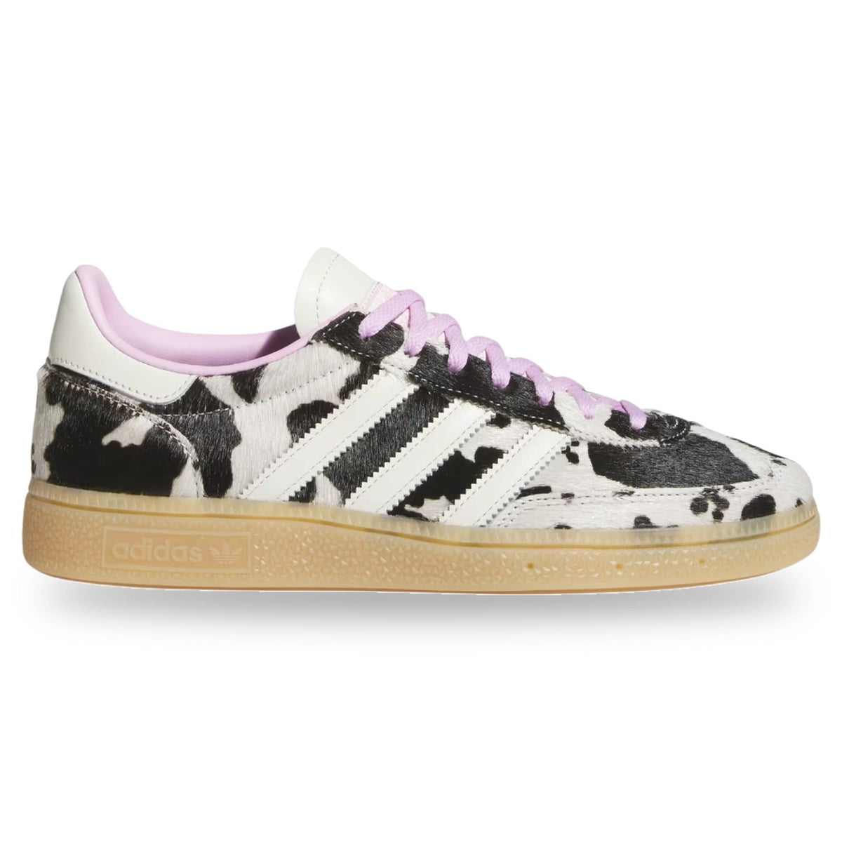 Adidas x Vetements Gazelle sneaker featuring a black and white cow print pattern, white leather three-stripes, light pink laces and lining, and a translucent gum sole.